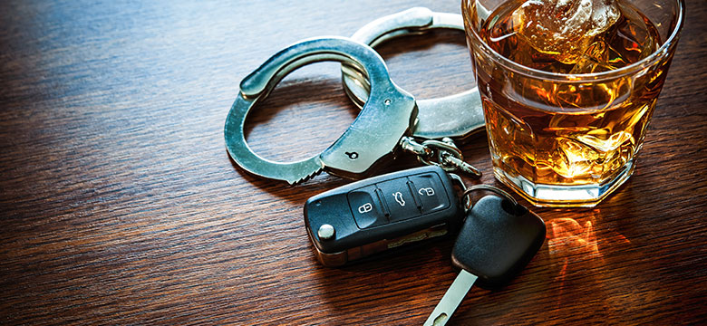 DUI symbolized with handcuffs and alcohol